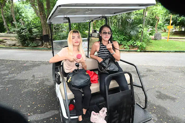 Mali and Phang at the zoo riding a golf kart